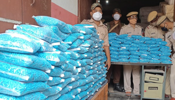 Police in India’s Assam state with bags of confiscated drugs (Anuwar Hazarika/NurPhoto/Shutterstock)