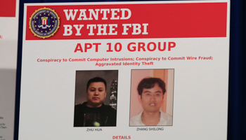 A poster at a US Department of Justice news conference in Washington shows two Chinese hackers charged for targeting US entities (Manuel Balce Ceneta/AP/Shutterstock)