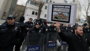 Pro-Islamic demonstrators, protesting on the anniversary of the National Security Council meeting that ousted the Islamic-led government in 1997, display a poster labelled "post-modern coup", Ankara, February 28, 2013 (Burhan Ozbilici/AP/Shutterstock) 