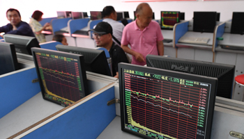 People watching stock market data, Fuyang, China, July 2021 (Sheldon Cooper/SOPA Images/Shutterstock)