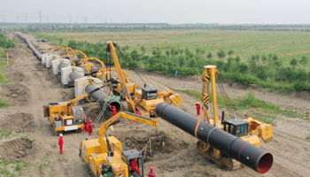 Workers installing an LNG pipeline in China, June 2021 (Xinhua/Shutterstock)