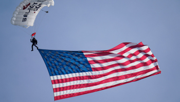 A skydiver approaches the stadium with a large flag before a college football game in Maryland, October 2 (Julio Cortez/AP/Shutterstock)