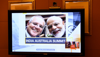 A photo of Australian Prime Minister Scott Morrison (left) and his Indian counterpart, Narendra Modi (right), displayed on a screen in Australia’s parliament ahead of the June 2020 virtual India-Australia summit (Lukas Coch/EPA-EFE/Shutterstock)