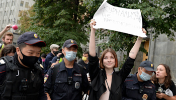 A Russian journalist with a placard saying “Journalism is not a crime” is detained while protesting on Moscow’s Lubyanka Square, home of the secret police, August 21, 2021 (Denis Kaminev/AP/Shutterstock)