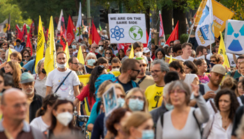 Demonstrators hold pro-nuclear power signs at a pre-COP26 march in Milan. October 2 (Alexander Pohl/Shutterstock)