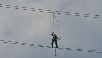 Electrician working on high voltage cables, Philippines, May 2020 (Sherbien Dacalanio/Pacific Press/Shutterstock)