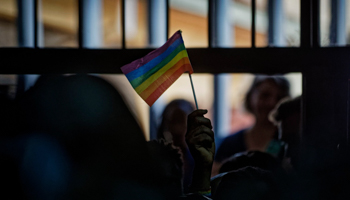 An LGBT activist waves a rainbow flag inside the courtroom, as Kenya’s High Court upheld a colonial-era prohibition on same-sex relations, May 24, 2019 (Ben Curtis/AP/Shutterstock)