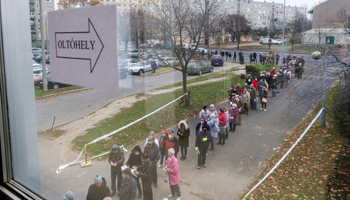 People queue to be vaccinated against COVID-19 outside the Petz Aladar hospital, under a government campaign for all 101 hospitals in Hungary to offer jabs without an appointment during November 22-28, Gyor, November 22 (Csaba Krizsan/EPA-EFE/Shutterstock)