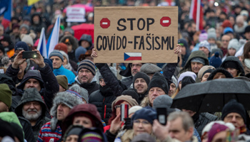 A protester holds up a banner, Stop COVID-fascism, during a march against increased restrictions under the state of emergency introduced from November 26, Prague, November 28 (Martin Divisek/EPA-EFE/Shutterstock)