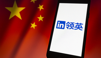 LinkedIn logo, in Chinese, on a smartphone backdropped by Chinese flag (Andre M Chang/ZUMA Press Wire/Shutterstock)