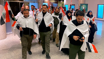 Sadrist lawmakers enter the first new parliamentary session wearing shrouds, January 9 (Ali Abdul Hassan/AP/Shutterstock)
