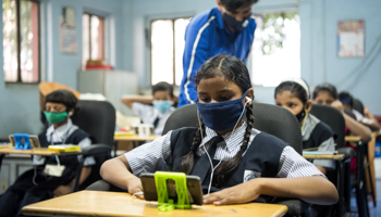 Students access e-learning content on mobile phones at the 'Online Education Mobile Library', Mumbai, India (Shutterstock / Manoej Paateel)