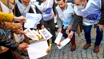 Public service trade unionists in Izmir burn their pay slips in protest against high inflation in Turkey and the rising cost of living after price rises for electricity, gas, fuel, transport and food, Izmir, January 14 (Idil Toffolo/Shutterstock)