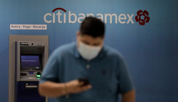 A person in front of a Citibanamex ATM at Mexico City International Airport (Gerardo Vieyra/NurPhoto/Shutterstock)