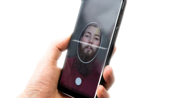 Illustration of a deepfake human image being used on a mobile phone (Shutterstock / A-photographyy)