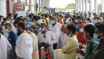 Bangladeshi migrants waiting for plane to Saudi Arabia (Suvra Kanti Das/ZUMA Press Wire/Shutterstock)