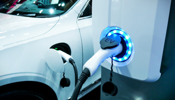 Power supply connect to electric vehicle for charge to the battery (Shutterstock / buffaloboy)