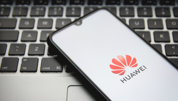 Huawei logo shown on a smartphone with a keyboard in the background (Nikolas Kokovlis/NurPhoto/Shutterstock)