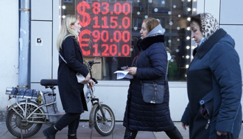A money exchange sign shows the value of the ruble plunging (Pavel Golovkin/AP/Shutterstock)