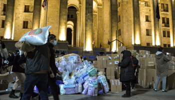 Volunteers pack humanitarian supplies for Ukraine donated at a pro-Kyiv rally outside the Georgian parliament in Tbilisi, March 6 (Nicolo Vincenzo Malvestuto/SOP/Shutterstock)