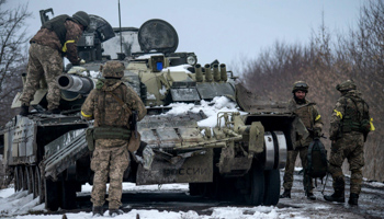 Ukrainian soldiers inspect a disabled tank abandoned by Russian forces in the south-east, March 8, 2022  (EyePress News/Shutterstock)