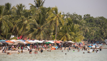 People enjoy a beach in Boca Chica, Dominican Republic. October, 2021 (Orlando Barria/EPA-EFE/Shutterstock)
