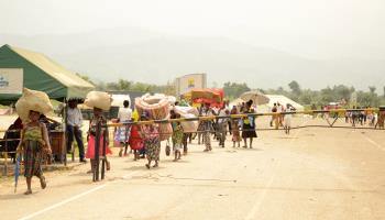 Refugees cross the DRC-Uganda border following a rebel attack, February 3, 2022 (Xinhua/Shutterstock)