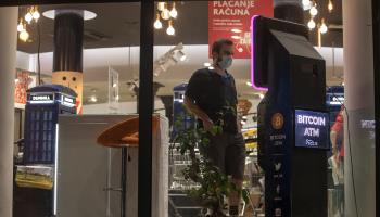 Man buying bitcoins from a cryptocurrency ATM in Belgrade, Serbia (Shutterstock)