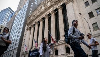Pedestrians pass the New York Stock Exchange, May (John Minchillo/AP/Shutterstock)