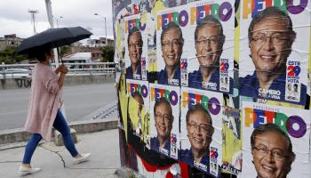 A woman walks past Petro election campaign posters in Bogota, Colombia. May 27 (Mauricio Duenas Castaneda/EPA-EFE/Shutterstock)