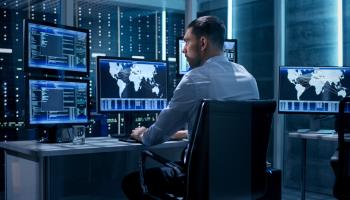 A cybersecurity professional at his workstation (Shutterstock)