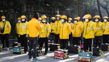 Meituan's food delivery workers at morning briefing before work (Shutterstock)