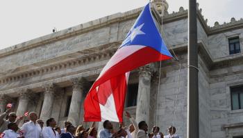 Member of the legislature raise the Puerto Rico flag in San Juan, July 26 (Thais Llorca/EPA-EFE/Shutterstock)