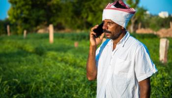 Indian farmer using his smartphone (Shutterstock)