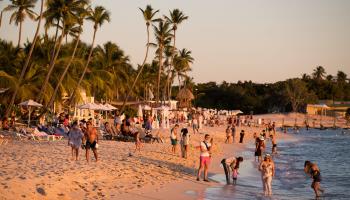 Tourists enjoy the sunset at Bayahibe beach, Dominican Republic. January 23, 2021 (Orlando Barria/EPA-EFE/Shutterstock)