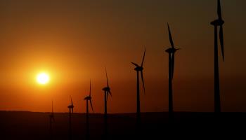 The sun sets behind wind turbines in Germany (Matthias Schrader/AP/Shutterstock)