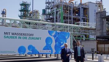 German Chancellor Olaf Scholz (L), accompanied by Infraserv Hoechst Managing Joachim Kreysing (R), stand in front of a banner reading "With hydrogen, a clean future" during a visit to a hydrogen fuel station for trains at the Hoechst Industrial Park, Frankfurt am Main, August 09 (Ronald Wittek/EPA-EFE/Shutterstock)