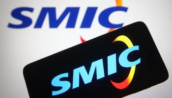 Logo of Chinese semiconductor company SMIC, seen on a smartphone and monitor (Pavlo Gonchar/SOPA Images/Shutterstock)