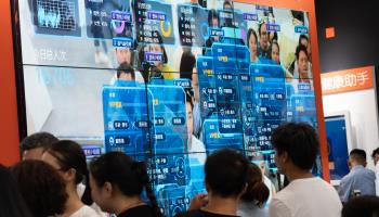 Visitors review facial identification technology at Smart China expo, Chongqing, China (Shutterstock)
