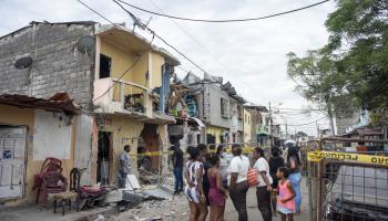 Residents of Guayaquil's Cristo del Consuelo neighborhood observe the damage caused by the bombing that took place there on August 14 (Mauricio Torres/EPA-EFE/Shutterstock)