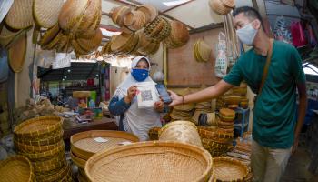 A bamboo craft seller using digital payments in Kediri, Indonesia (Ahmad Saifulloh/Shutterstock)