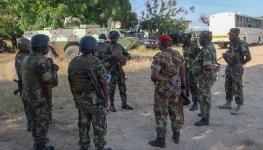Rwandan and Mozambican forces discuss operations following the recapture of Mocimboa da Praia, August 9, 2021 (Marc Hoogsteyns/AP/Shutterstock)