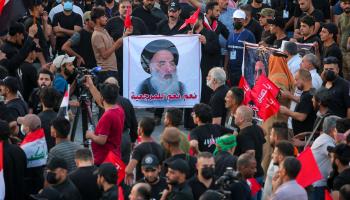 Supporters of the Coordination Framework carry a photo of Grand Ayatollah Ali al-Sistani, Baghdad, Iraq, August 12 (Anmar Khalil/AP/Shutterstock)