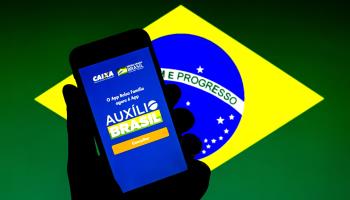 The Auxilio Brasil welfare programme app superimposed on the Brazilian flag (Thiago Prudencio/DAX via ZUMA Press Wire/Shutterstock)