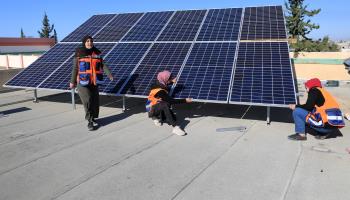 Palestinian women install solar panels on a school rooftop, al-Qaara, Gaza Strip, Februray 1, 2021 (Xinhua/Shutterstock)