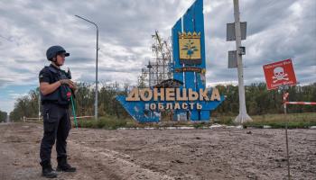 A Ukrainian soldier in front of a sign marking the start of Donetsk region (Yevhen Honcharenko/EPA-EFE/Shutterstock)