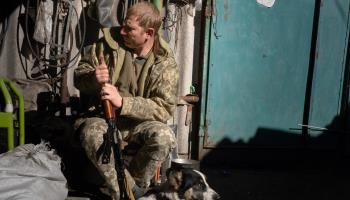 A Ukrainian soldier cleans his rifle in a newly recaptured area (Ashley Chan/SOPA Images/Shutterstock)