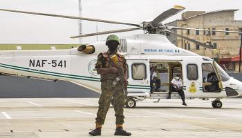 Soldier standing guard in front of presidential helicopter (Olukayode Jaiyeola/NurPhoto/Shutterstock)