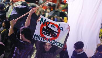 A protester holds a placard during demonstrations against militarisation. Mexico City, September (Guillermo Diaz/SOPA Images/Shutterstock)