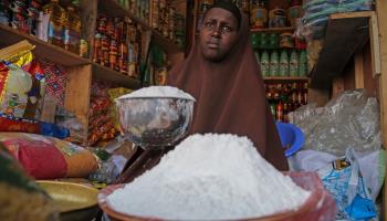 A shopkeeper sells wheat flour in Mogadishu as inflation drives rising prices, May 26, 2022 (Farah Abdi Warsameh/AP/Shutterstock)